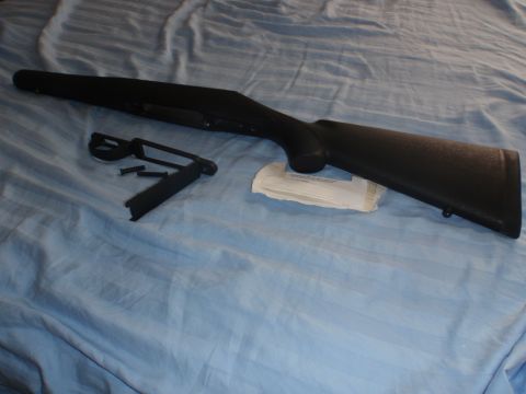 1991 Ford Bronco - Rifle stock and parts laid out on a blue cloth.