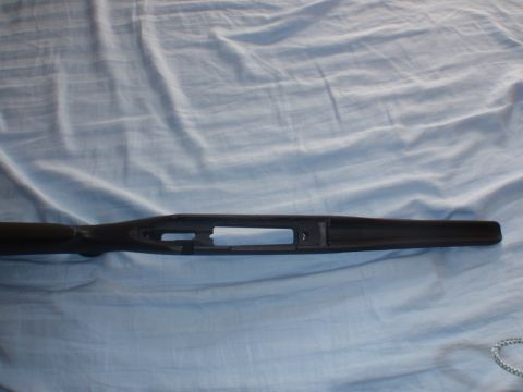 1991 Ford Bronco - A black rifle stock is shown laid out on a blue cloth surface.
