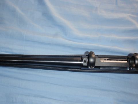 1991 Ford Bronco - Close-up view of a rifle's bolt action mechanism against a blue fabric background.