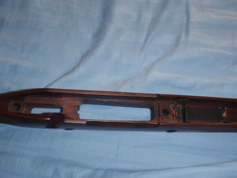 1991 Ford Bronco - A wooden rifle stock is shown, revealing its internal structure and metal fittings.