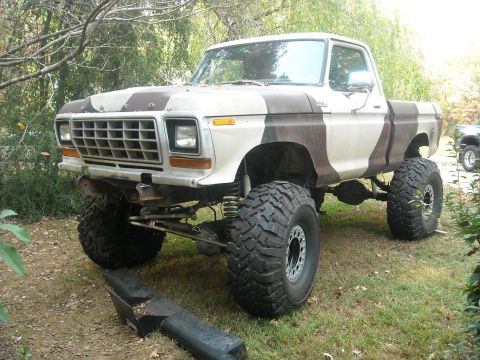 1979 Ford F-150 - This lifted 1977 Ford F-150 pickup truck is painted in a camouflage pattern and equipped with large off-road tires.