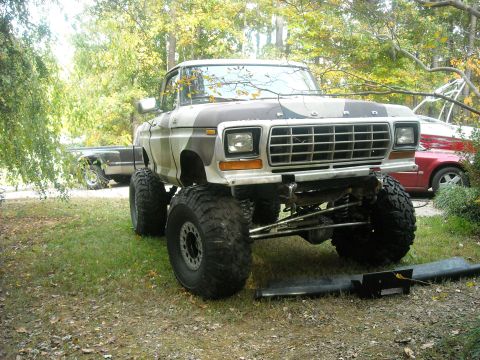 1979 Ford F-150 - A heavily modified 1979 Ford F-150 pickup truck is shown with a lifted suspension and oversized off-road tires.