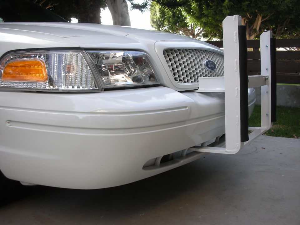 Front of a white 2004 Ford Crown Victoria with a white push bumper installed