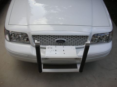 2004 Ford Crown Victoria - Front view of a white Ford Crown Victoria equipped with a push bumper and license plate bracket.