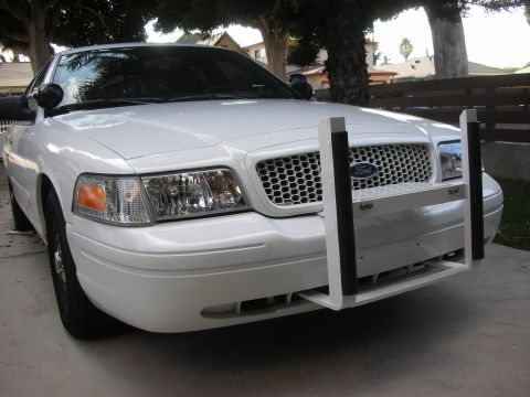 2004 Ford Crown Victoria - Front view of a white 2004 Ford Crown Victoria equipped with a push bumper.