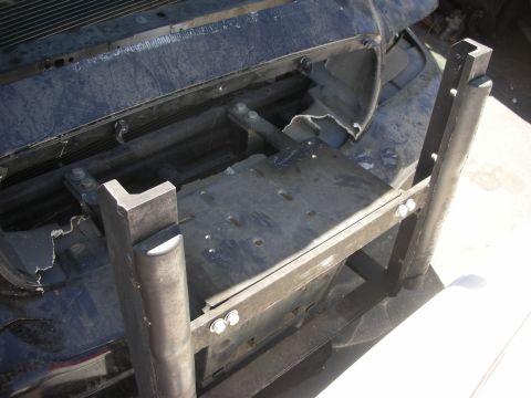 2004 Ford Crown Victoria - A close-up view of the front bumper area of a 2004 Ford Crown Victoria, modified with a push bar.