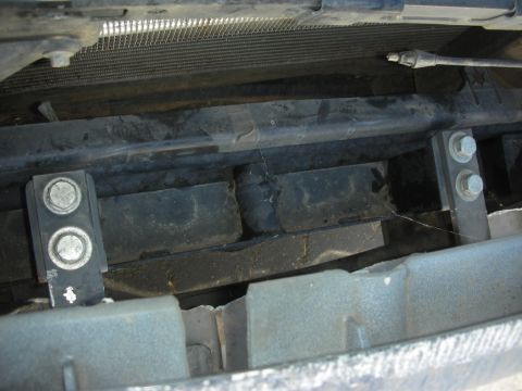 2004 Ford Crown Victoria - Close-up view of the mounting hardware for a push bumper, showing bolts and brackets.