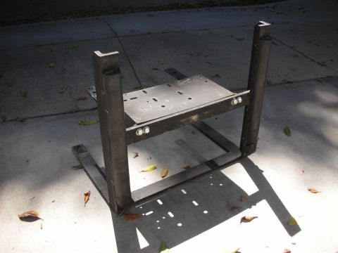 2004 Ford Crown Victoria - A welded steel fabrication project sits on a concrete driveway, consisting of two vertical uprights and a horizontal mounting plate with bo…
