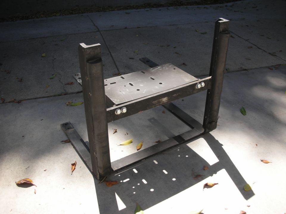 Welded steel mounting frame with two uprights and bolted plate on concrete