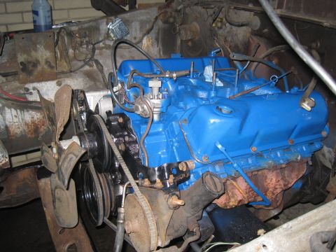 1979 Ford Bronco - Close-up view of a blue-painted engine, likely undergoing restoration or repair.