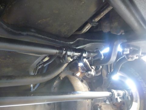 1997 Dodge 2500 - Underside view of vehicle steering linkage and driveshaft components.