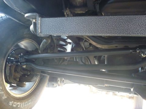 1997 Dodge 2500 - Close-up view of the vehicle's undercarriage, focusing on suspension and steering parts.