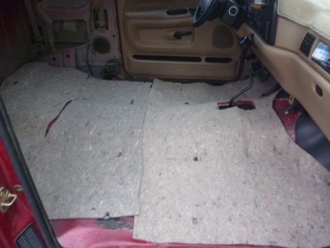 1997 Dodge 2500 - The interior of a truck shows the floor stripped of its carpet, revealing the underlying structure.