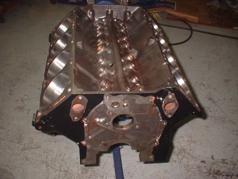1964 Ford Galaxie - An engine block is shown from a top-down perspective, resting on a stand.