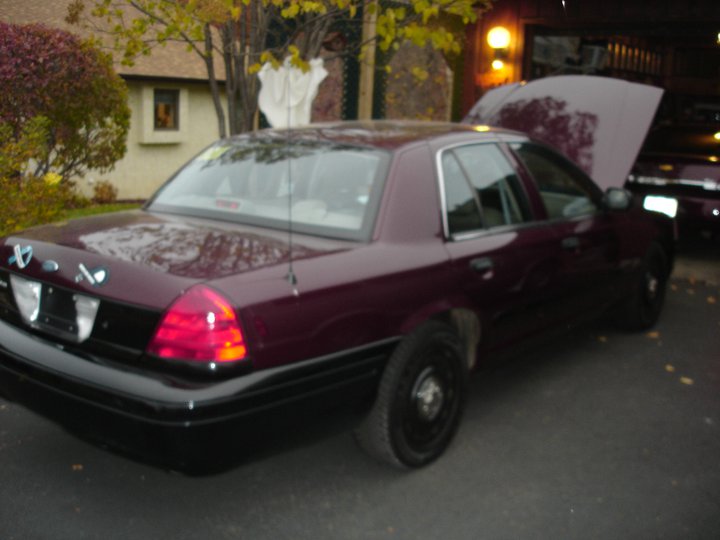 Maroon 2005 Ford Crown Victoria, rear 3/4 view, hood open