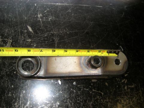 1996 Ford Bronco - A metal bracket is shown with a tape measure indicating its length.