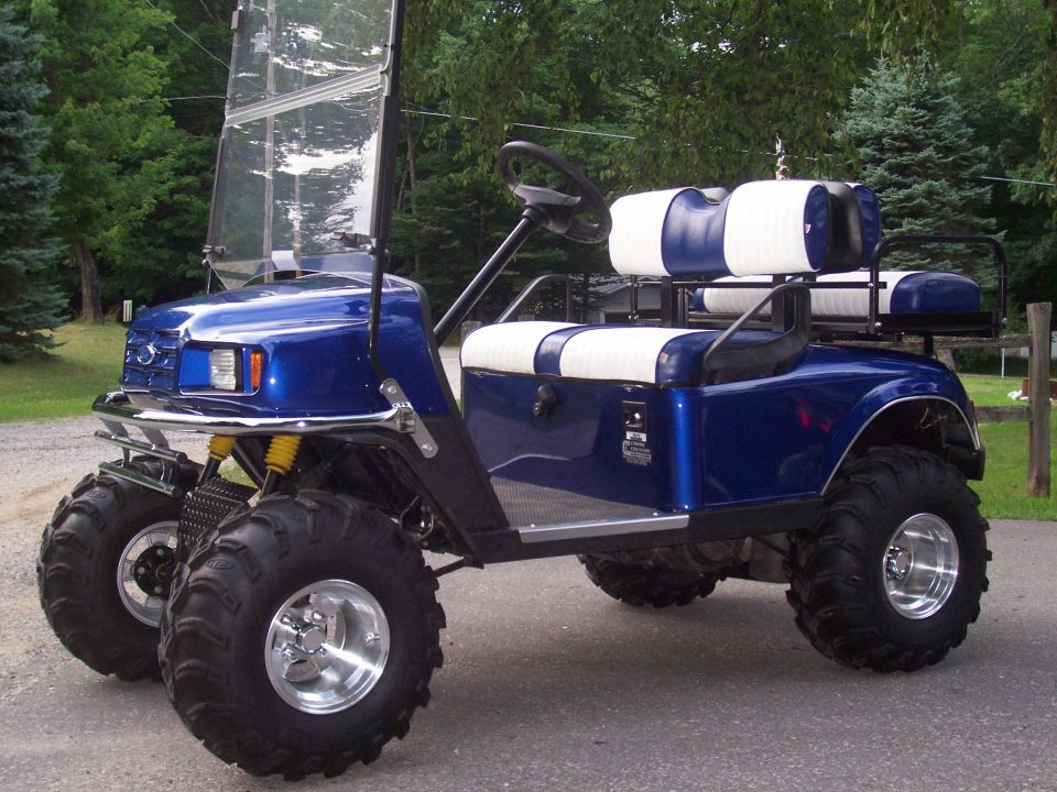 Blue golf cart with oversized tires and custom seats