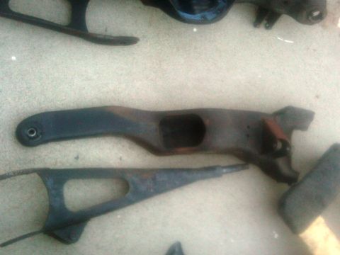 1986 Ford Bronco - Various automotive parts, appearing to be suspension components, are shown on a textured surface.
