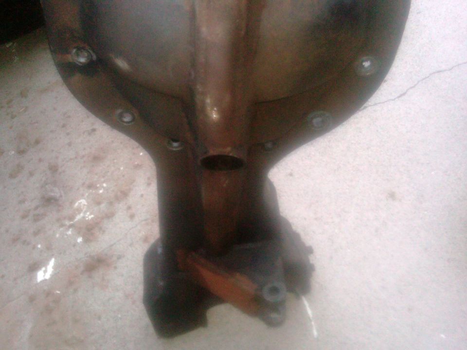 Rusty differential housing with bolt holes visible