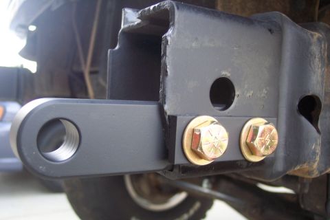 1995 Ford Bronco - Close-up of a trailer hitch receiver and its mounting hardware.