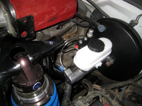 1996 Ford Bronco - Close-up view of a vehicle's brake booster and master cylinder assembly.