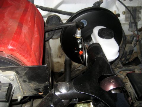 1996 Ford Bronco - Close-up view of the brake booster and master cylinder assembly, likely part of a brake system upgrade or repair.