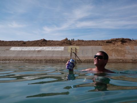 1982 Ford Bronco - A man enjoys a swim in the water, with a 'No Trespassing' sign visible on the concrete wall.