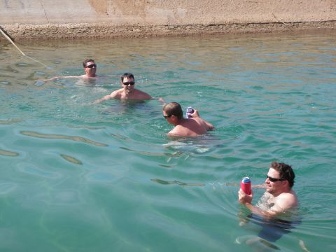 1982 Ford Bronco - Men enjoy a swim in a canal, holding drinks.