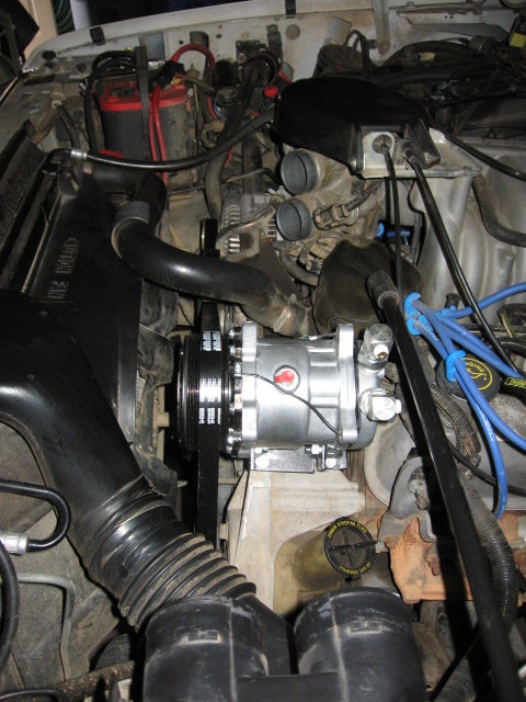 1995 Ford Bronco - The engine bay shows a newly installed belt-driven air conditioning compressor, not original equipment.