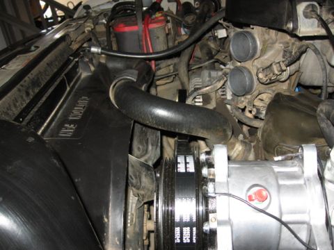 1995 Ford Bronco - Close-up view of an engine bay, highlighting the air conditioning compressor and associated components.