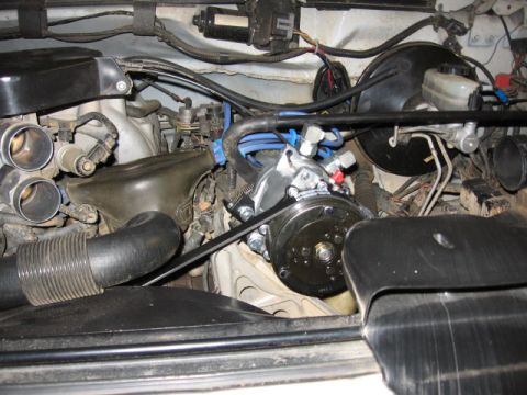 1995 Ford Bronco - Engine bay view of a 1995 Ford Bronco, highlighting the belt-driven air conditioning compressor.
