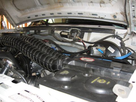 1995 Ford Bronco - Close-up of a vehicle's engine bay, focusing on the air intake system and brake components.