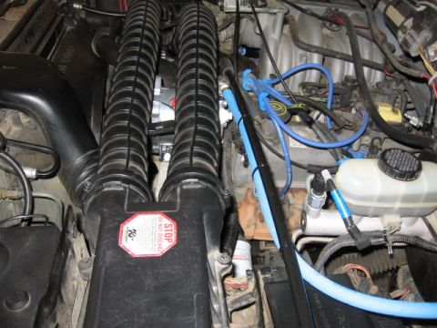 1995 Ford Bronco - Close-up view of the engine bay of a 1995 Ford Bronco, showing the air intake system and engine components.