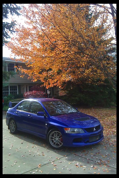 2006 Mitsubishi Evolution - Blue Mitsubishi Lancer Evolution VIII parked in a driveway with fall foliage overhead.