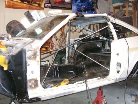 1978 Ford Mustang II - Stripped-down 1978 Ford Mustang II interior shows roll cage installation progress.