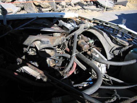1991 Ford LTD Crown Victoria - Close-up view of a car's engine bay, showing various mechanical parts and wiring.