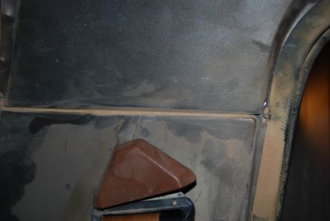 1982 Ford Bronco - Close-up of a vehicle's interior door panel and seatbelt buckle, with a Supermotors.net watermark.