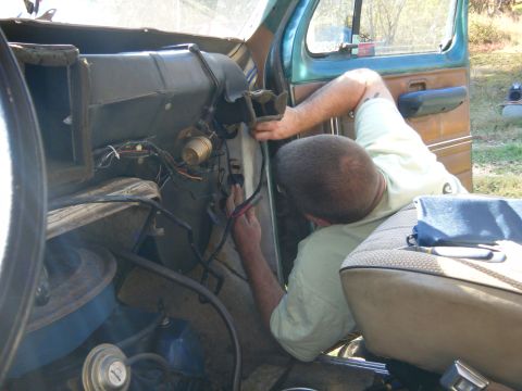 1981 Ford E350 - Interior view of a vehicle with a person working on the dashboard wiring.