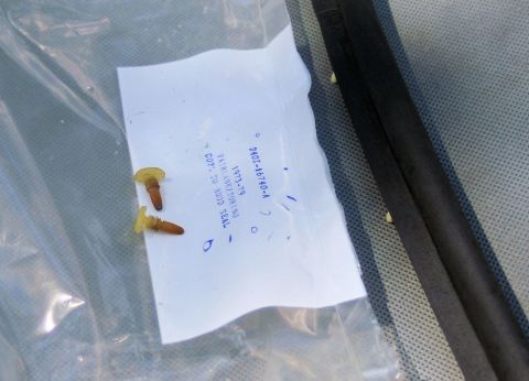 1976 Ford Ranchero - A document with part numbers and dates, along with two plastic fasteners, is visible in the image.