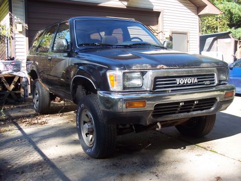 2006 Chevrolet Corvette - Front view of a black Toyota 4Runner, likely from the early 1990s, with a V6 badge visible on the grille.