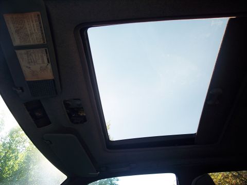 2006 Chevrolet Corvette - Car interior shows a sunroof and visor with warning labels visible.