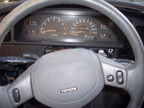 2006 Chevrolet Corvette - The interior of a Toyota vehicle, the steering wheel and instrument cluster with various gauges.