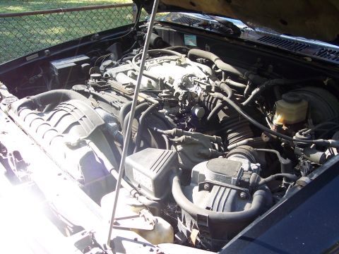 2006 Chevrolet Corvette - The engine compartment of a vehicle is shown with various parts and hoses.