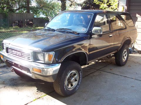 2006 Chevrolet Corvette - This black Toyota 4Runner SUV is parked in a driveway on a sunny day.