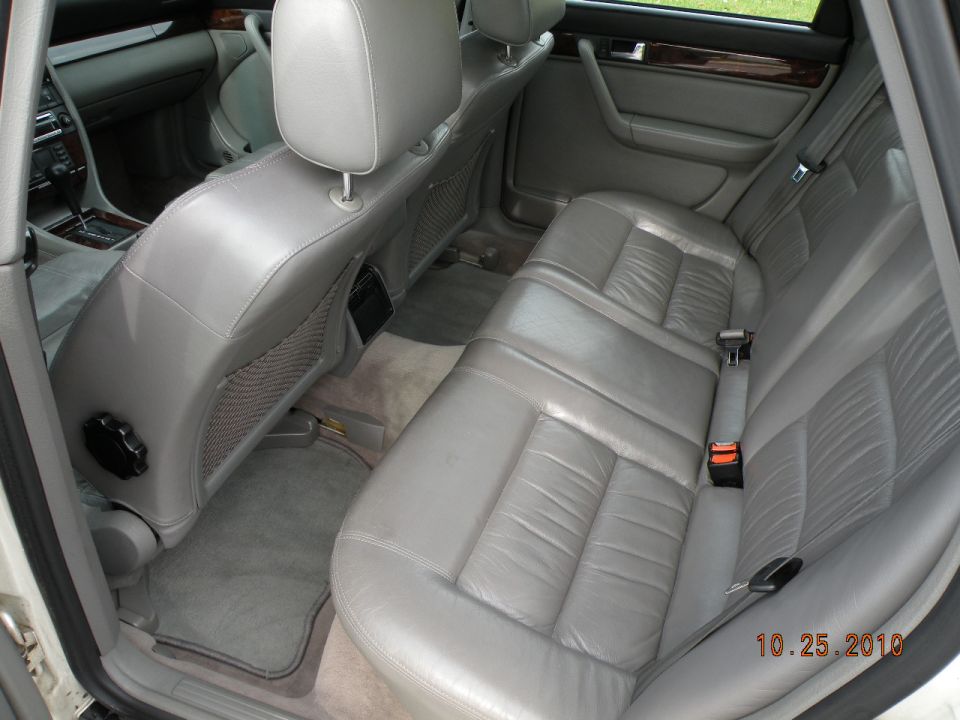 Gray leather interior of a 1995 Audi A6, showing the rear seats and door panels