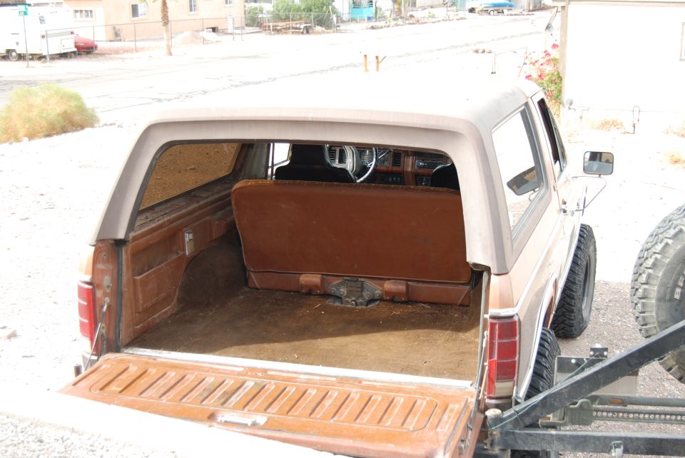 Rear interior of a 1982 Ford Bronco with brown seats and carpet