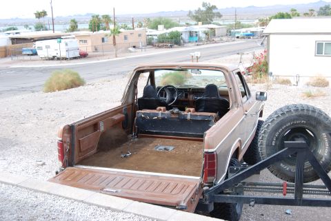 1982 Ford Bronco - Rear view of a 1982 Ford Bronco showing the interior, bed, and spare tire carrier.