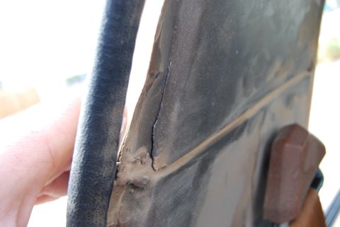 1982 Ford Bronco - Detail of a damaged metal panel with visible crack and trim, Supermotors.net logo present.