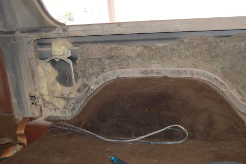 1982 Ford Bronco - Exposed insulation and wiring in the rear interior of a vehicle.