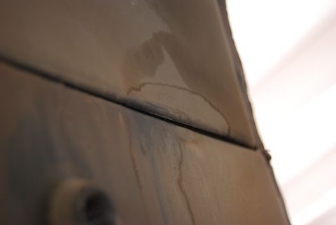 1982 Ford Bronco - Water stains are visible on a dark panel with a distinct seam.